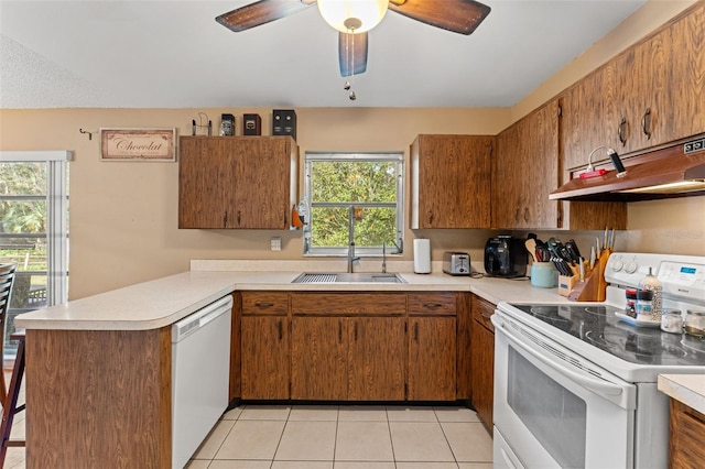 kitchen with ceiling fan, kitchen peninsula, white appliances, light tile patterned floors, and exhaust hood