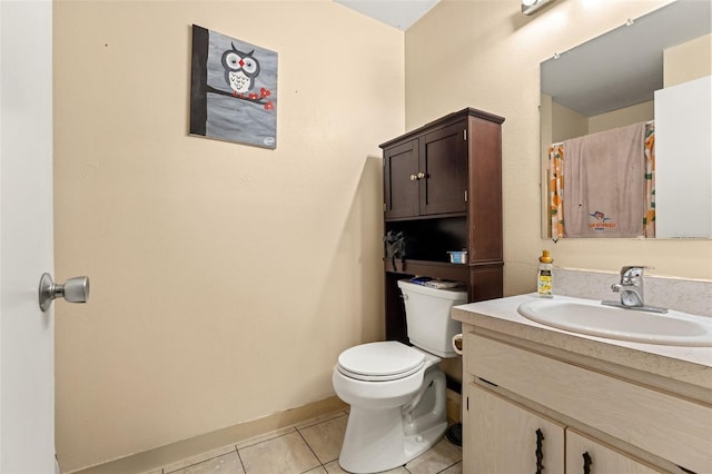 bathroom with tile patterned floors, vanity, and toilet