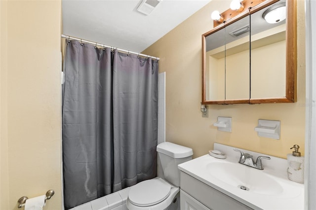 bathroom featuring vanity, toilet, and walk in shower