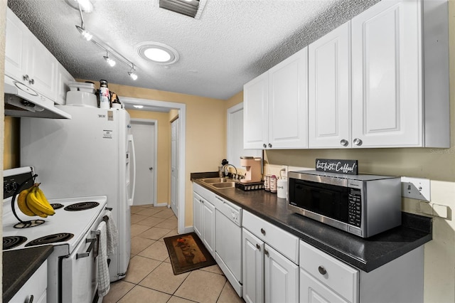 kitchen featuring white appliances, sink, light tile patterned floors, a textured ceiling, and white cabinetry