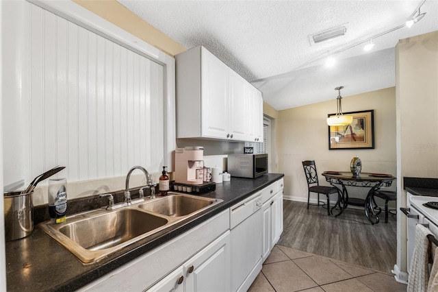 kitchen featuring a textured ceiling, white appliances, light hardwood / wood-style flooring, and white cabinetry