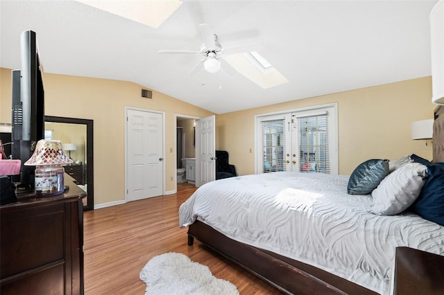 bedroom featuring lofted ceiling with skylight, french doors, ceiling fan, access to exterior, and wood-type flooring