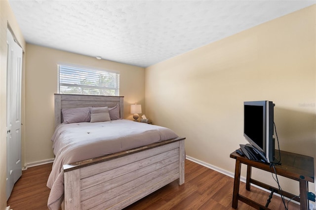 bedroom featuring a closet, hardwood / wood-style floors, and a textured ceiling