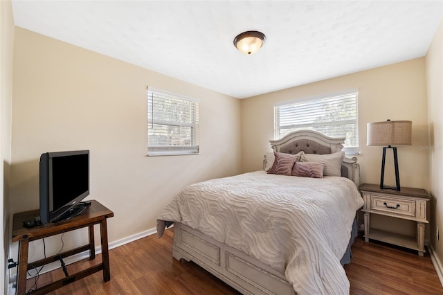 bedroom with dark hardwood / wood-style flooring