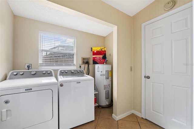 clothes washing area featuring water heater, light tile patterned floors, and independent washer and dryer