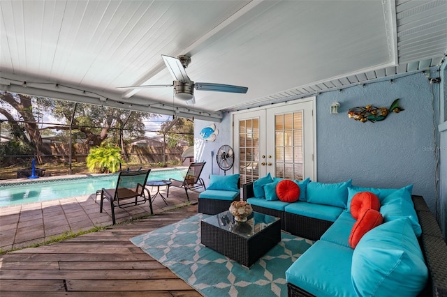 view of patio featuring ceiling fan, a lanai, an outdoor hangout area, and french doors