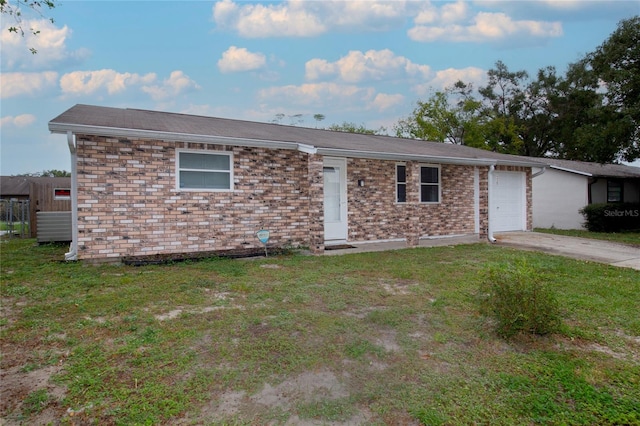 single story home with a front yard and a garage