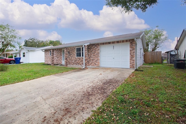 single story home featuring central AC unit, a garage, and a front yard