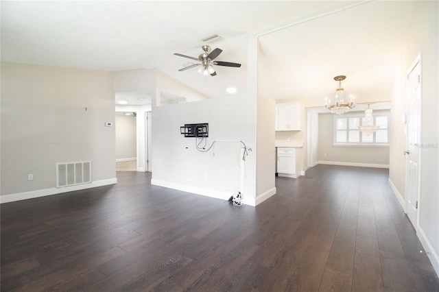 unfurnished living room featuring ceiling fan with notable chandelier, lofted ceiling, and dark wood-type flooring