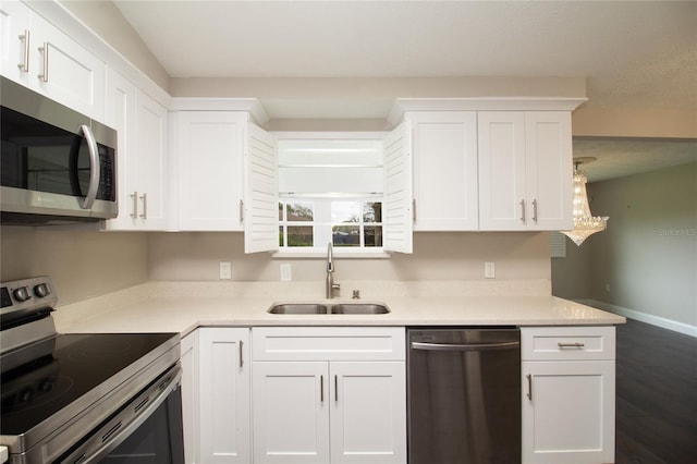 kitchen with white cabinets, appliances with stainless steel finishes, dark wood-type flooring, and sink