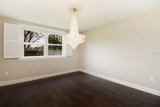 unfurnished dining area with dark hardwood / wood-style flooring and an inviting chandelier