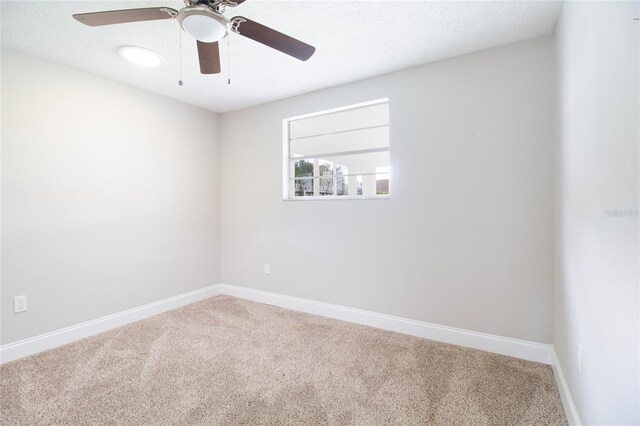 carpeted empty room with a textured ceiling and ceiling fan