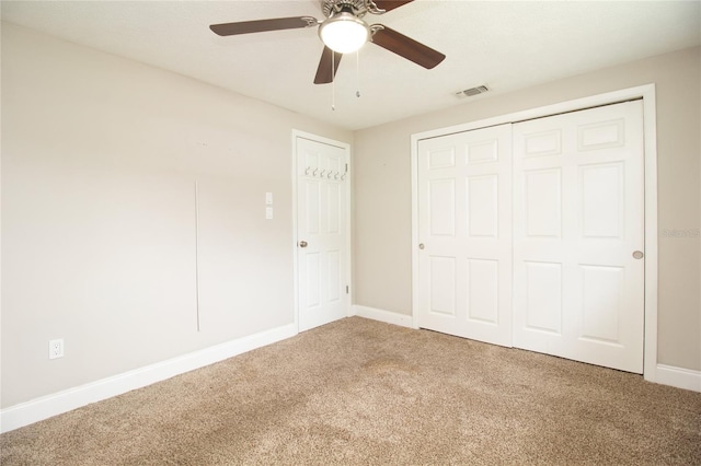 unfurnished bedroom featuring carpet, a closet, and ceiling fan