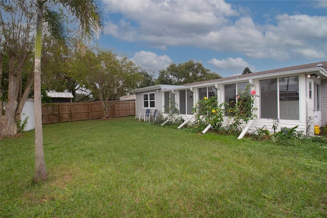 back of property featuring a lawn