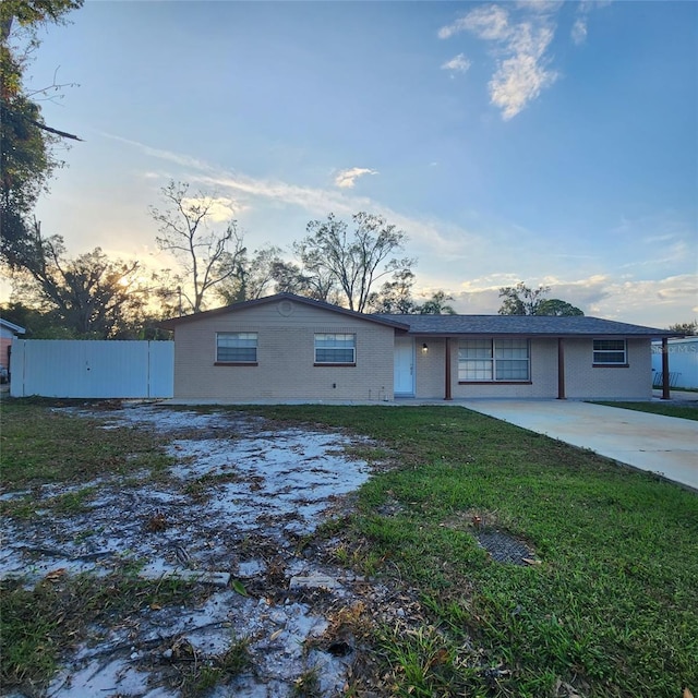 ranch-style home featuring a lawn