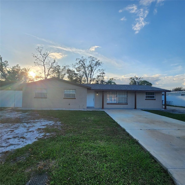 ranch-style house featuring a lawn