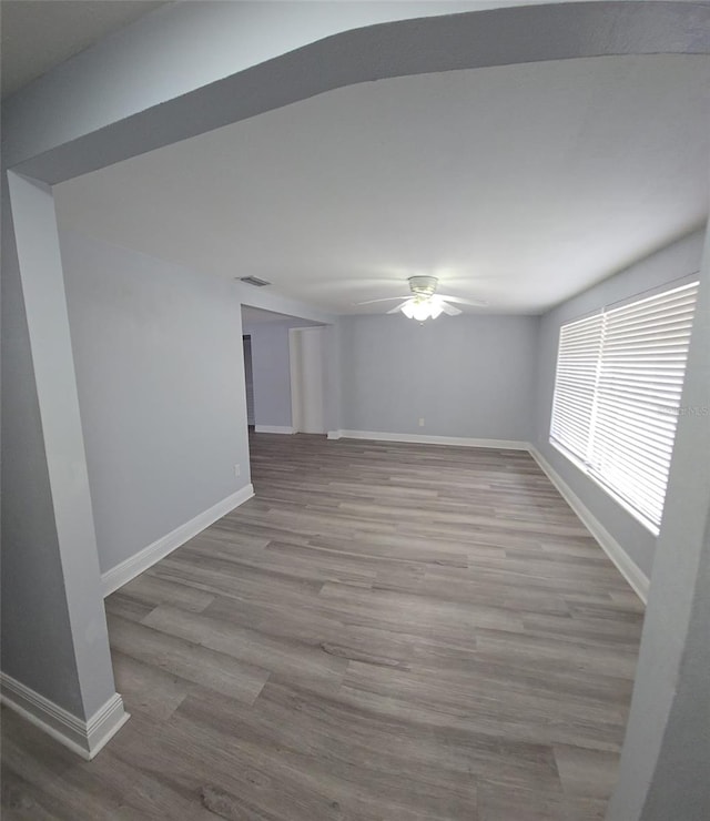 empty room with light wood-type flooring and ceiling fan