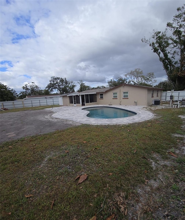 view of pool with a patio area and a yard