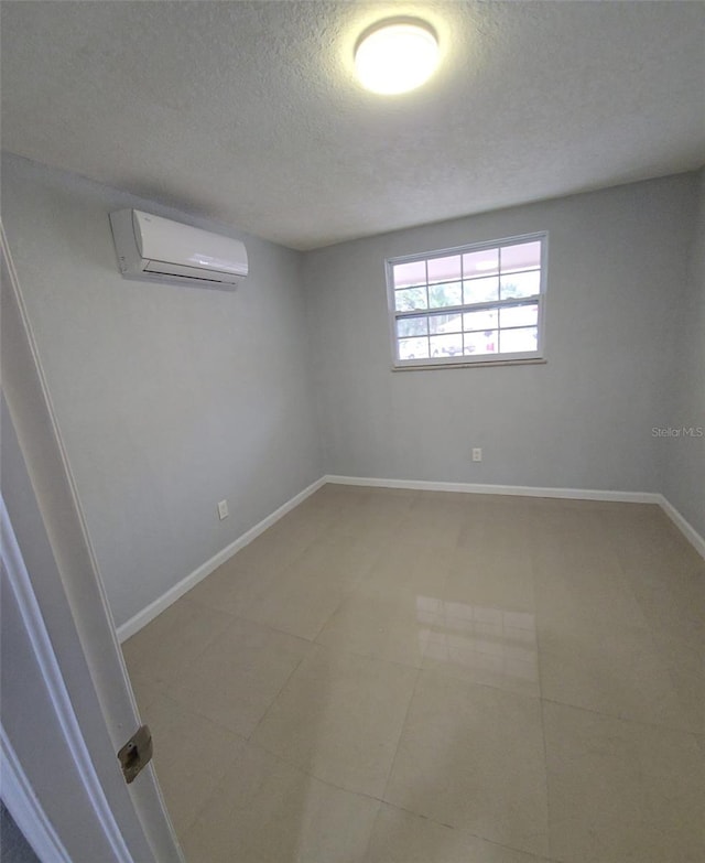 basement featuring an AC wall unit and a textured ceiling