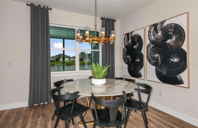 dining area with a notable chandelier, a water view, and dark wood-type flooring