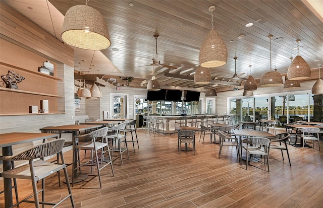 dining area with wood-type flooring and wooden ceiling