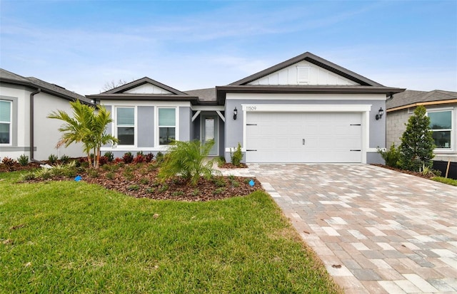 ranch-style house with a garage and a front lawn