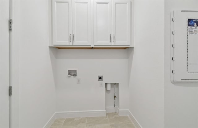 washroom with cabinets, washer hookup, hookup for an electric dryer, and light tile patterned floors