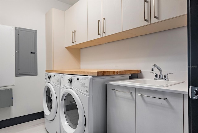 washroom featuring cabinets, separate washer and dryer, sink, and electric panel