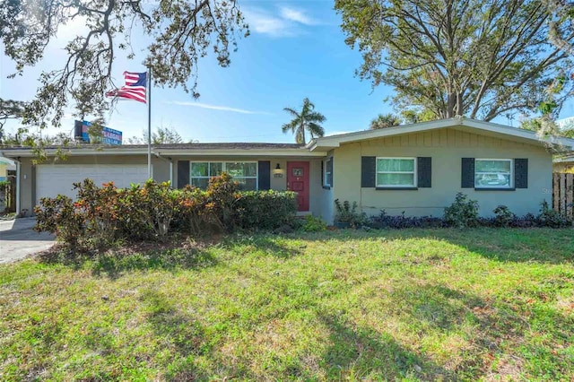 single story home with a front yard and a garage