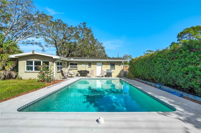 view of swimming pool featuring a grill