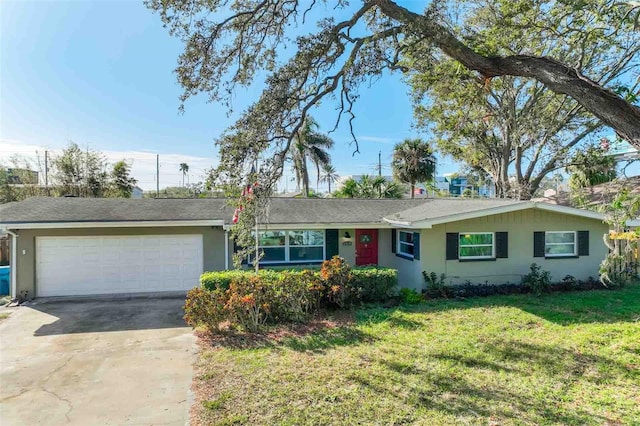 ranch-style house featuring a garage and a front lawn