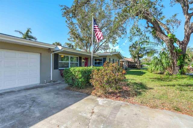 single story home featuring a front yard and a garage