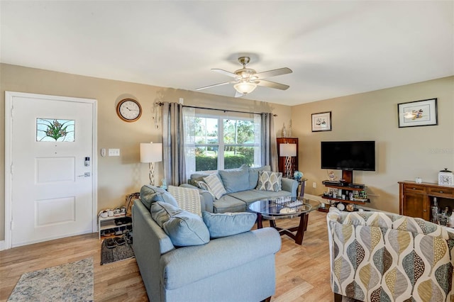 living room with light hardwood / wood-style floors and ceiling fan