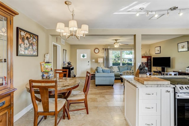 kitchen with white cabinetry, ceiling fan with notable chandelier, light tile patterned flooring, and decorative light fixtures