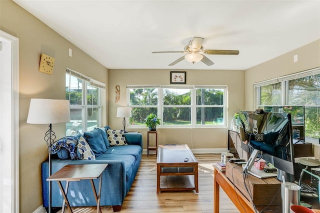 sunroom / solarium featuring ceiling fan