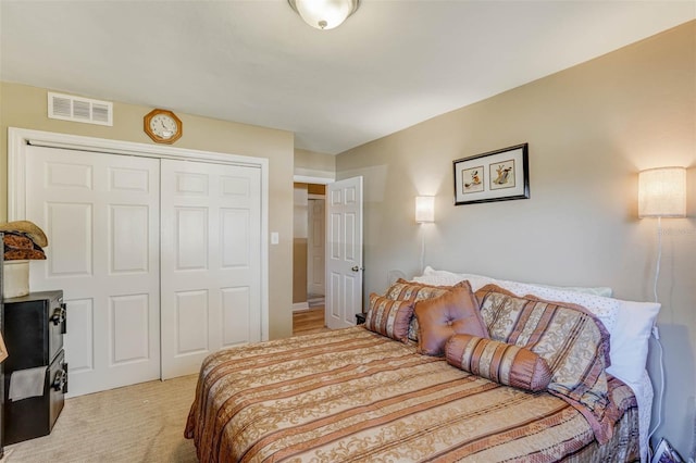 bedroom featuring light colored carpet and a closet