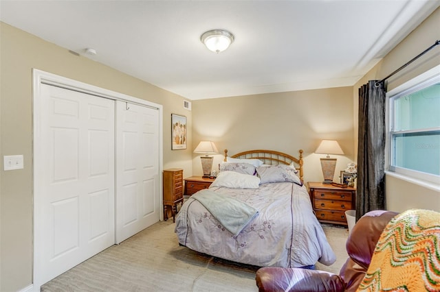 carpeted bedroom with a closet