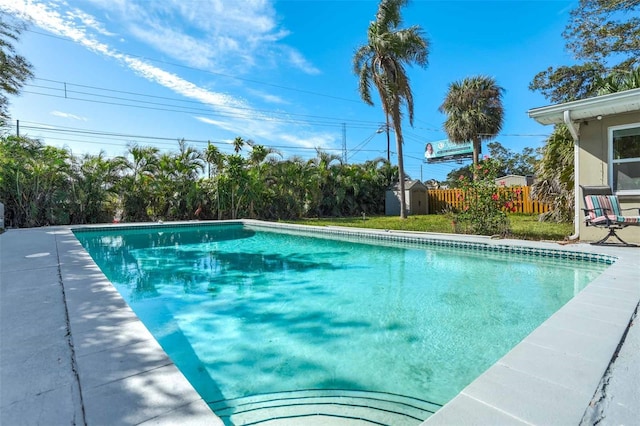 view of pool with a shed