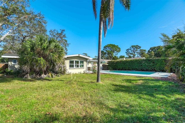 view of yard with a fenced in pool