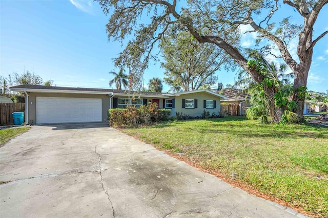 ranch-style house featuring a garage and a front lawn