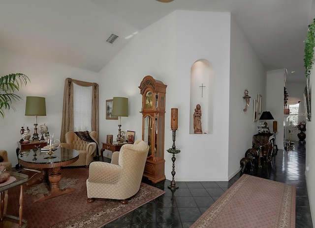 interior space featuring high vaulted ceiling and dark tile patterned flooring