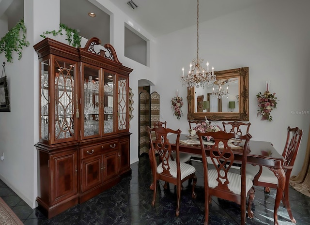 dining room featuring a high ceiling and a chandelier