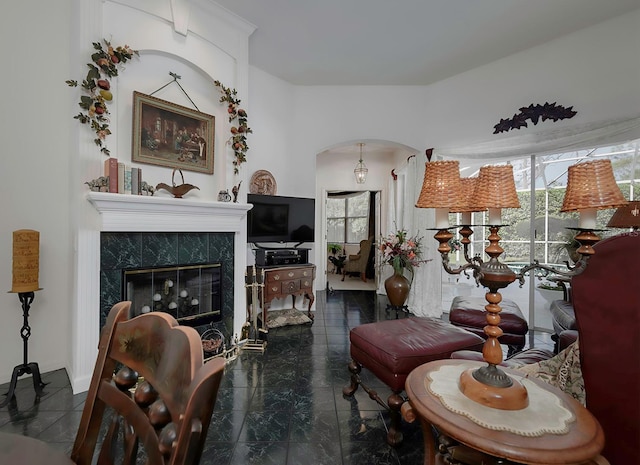 living room featuring a tile fireplace