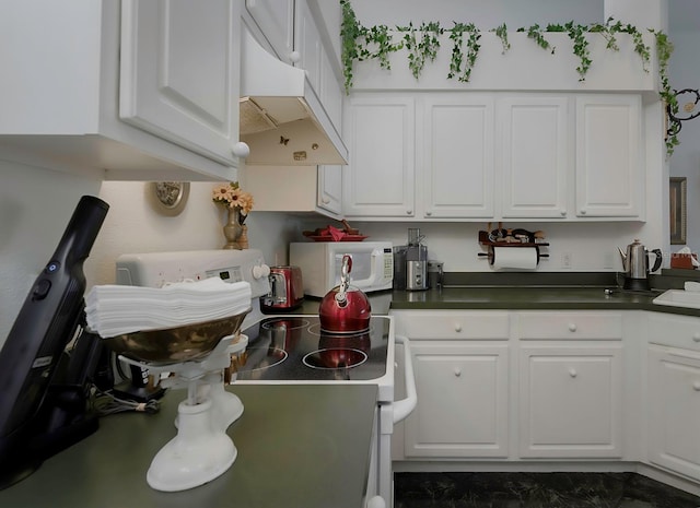 kitchen with white cabinets and white appliances