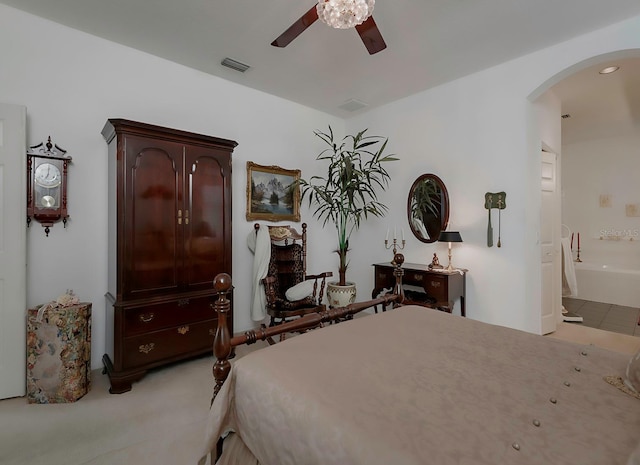 bedroom featuring connected bathroom, ceiling fan, and light carpet