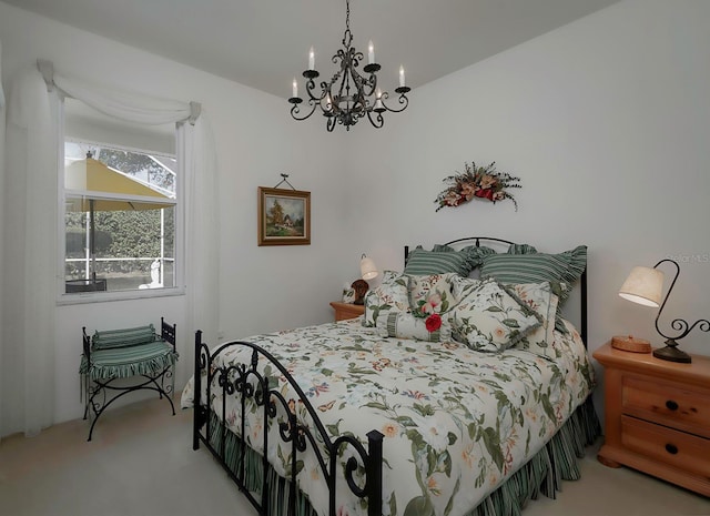 bedroom with carpet floors and a notable chandelier