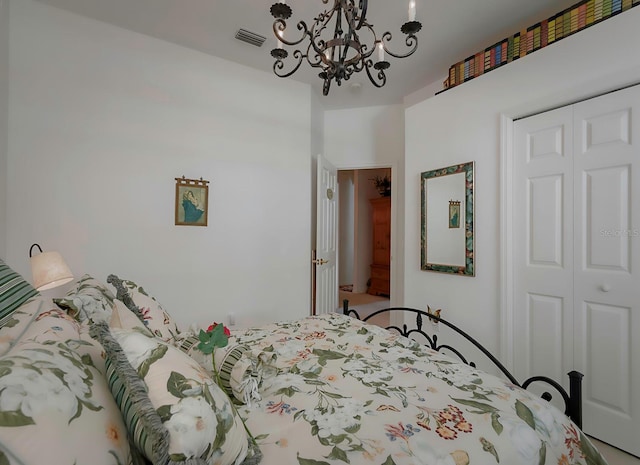 bedroom featuring an inviting chandelier and a closet