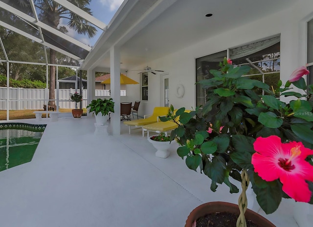 view of patio / terrace with ceiling fan and a lanai