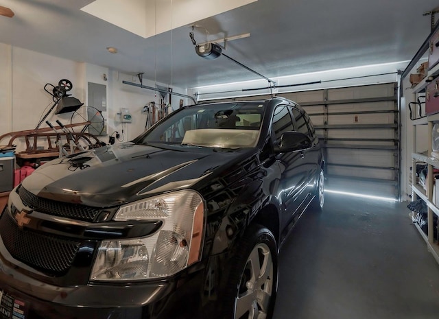 garage with electric panel and a garage door opener