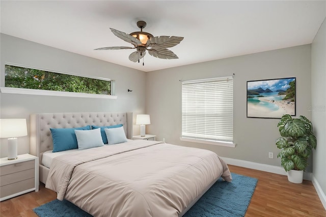 bedroom with light hardwood / wood-style floors, multiple windows, and ceiling fan